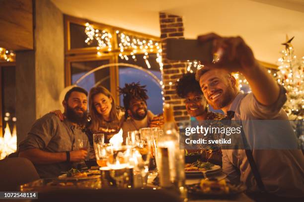 new year dinner celebration selfie - new years eve dinner stock pictures, royalty-free photos & images