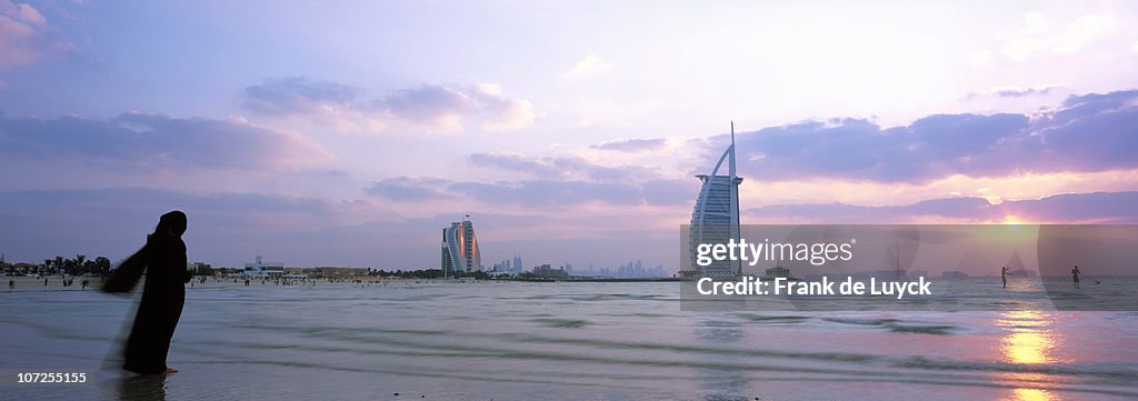 Woman admiring sunset, Dubai, United Arab Emirates