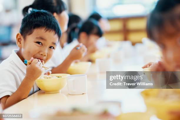 young children eating their school lunch at preschool - udon noodles stock pictures, royalty-free photos & images