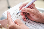 Elder person completing a crosswords