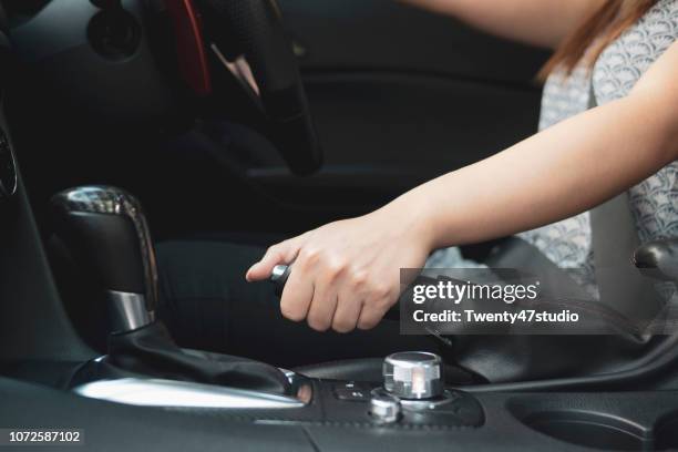 cropped hand holding hand brake in car - brake stock pictures, royalty-free photos & images