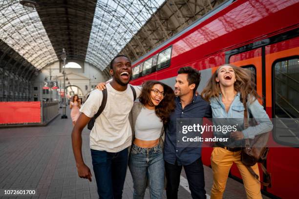 gelukkig groep vrienden reizen met de trein - man woman train station stockfoto's en -beelden