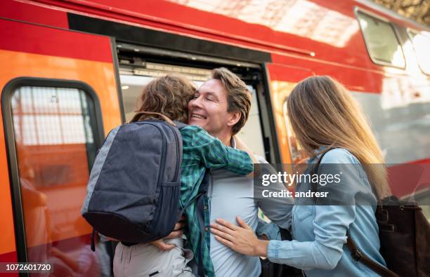 happy family at the train station greeting the father - moscow railway station stock pictures, royalty-free photos & images