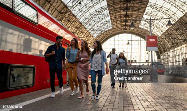 happy group of friends traveling by train - moscow railway station stock pictures, royalty-free photos & images