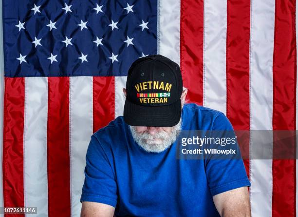 usa vietnam war us navy military veteran looking down - vietnam war stock pictures, royalty-free photos & images