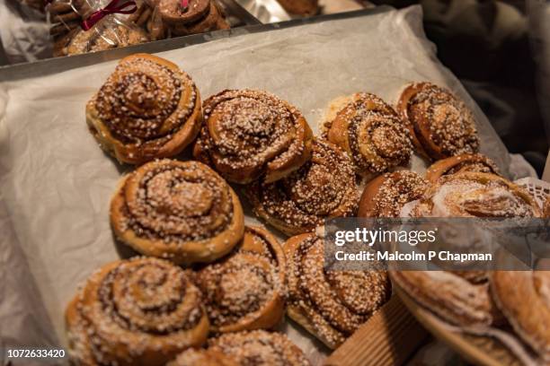 kanelbullar - swedish cinnamon buns or rolls, freshly baked. - cinnamon bun stock pictures, royalty-free photos & images