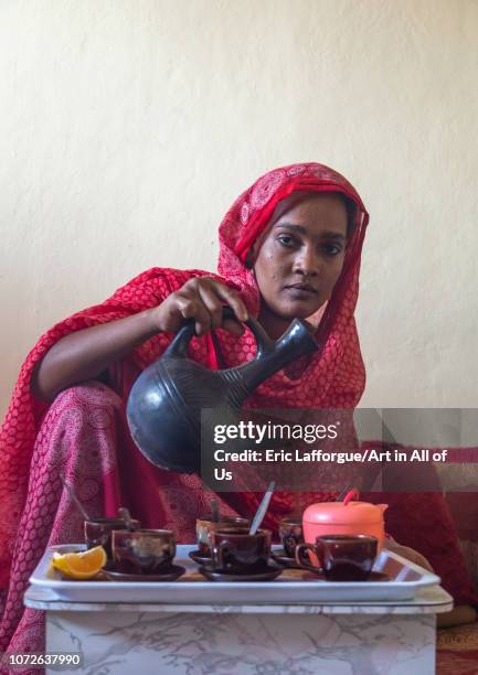 Ethiopian woman serving traditional coffee, Afar Region, Assayta, Ethiopia on November 1, 2018 in Assayta, Ethiopia.