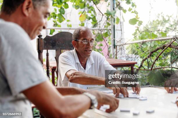 Good old latino friends playing dominos