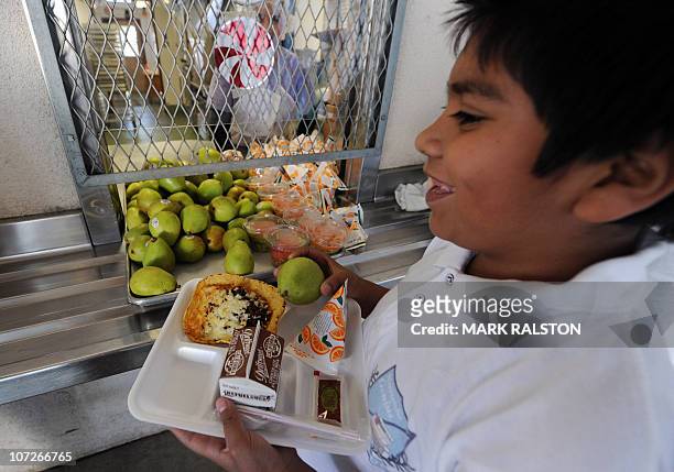 Cafeteria worker supervises lunches for school children at the Normandie Avenue Elementary School in South Central Los Angeles on December 2, 2010....