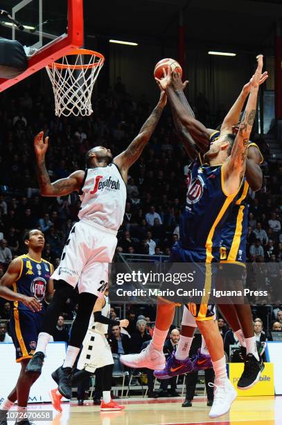 Amath M'Baye of Segafredo competes with Tony Carr and Carlos Delfino and Jamal Taylor of Fiat during the LBA Legabasket of Serie A1 match between...