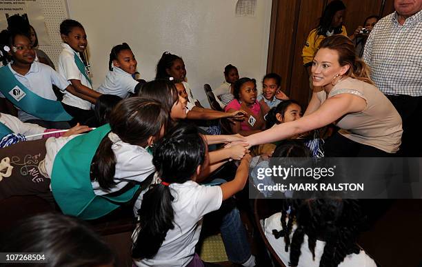 Singer and Actress Hilary Duff greets school children during her appearance for the "Blessings in a Backpack" food program at the Normandie Avenue...