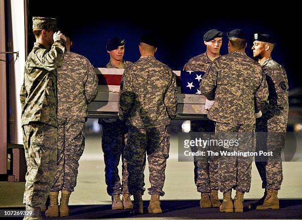 An honor guard delivers the flag draped casket containing the remains of Barry Jarvis of Tell City Indiana, killed in an ambush last monday in...