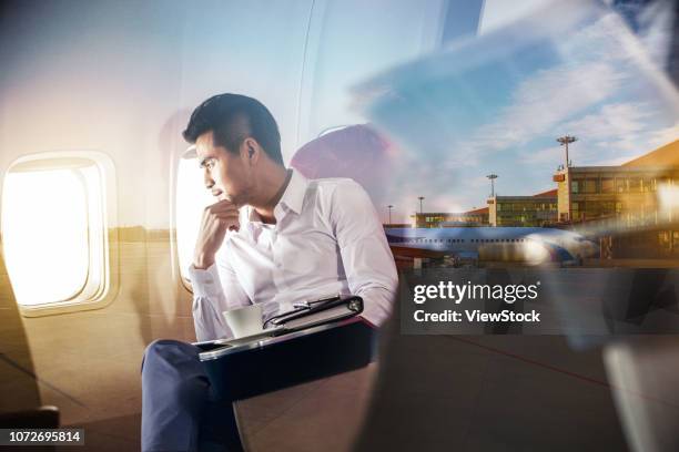 business man by plane - first class plane stock-fotos und bilder