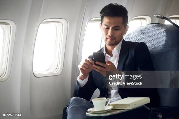 business man to travel by plane - first class plane stockfoto's en -beelden