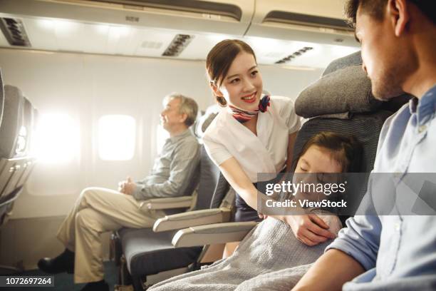 flight attendants and passengers on the plane - cabin crew stock-fotos und bilder