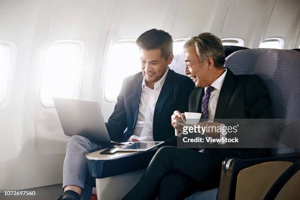 business people by plane - 飛行機の座席 ストックフォトと画像