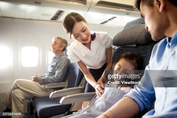 flight attendants and passengers on the plane - cabin crew stock-fotos und bilder