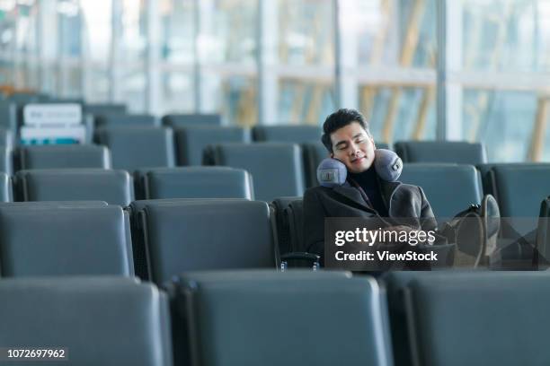 business man at the airport - neck pillow stock pictures, royalty-free photos & images