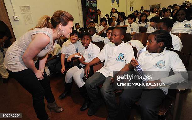 Singer and Actress Hilary Duff greets school children during her appearance for the "Blessings in a Backpack" food program at the Normandie Avenue...