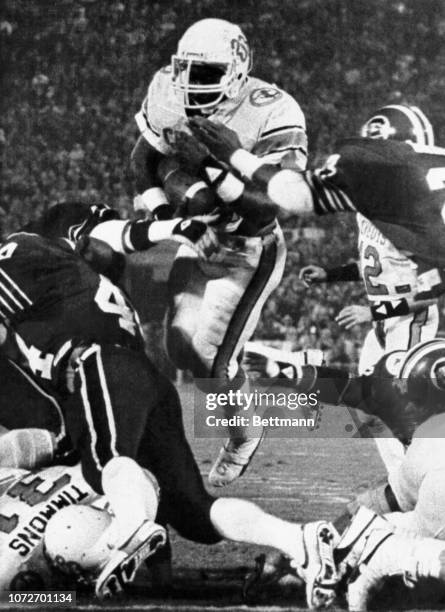 Oklahoma State's Thurman Thomas goes over the South Carolina defense for a touchdown in the first period of the Gator Bowl