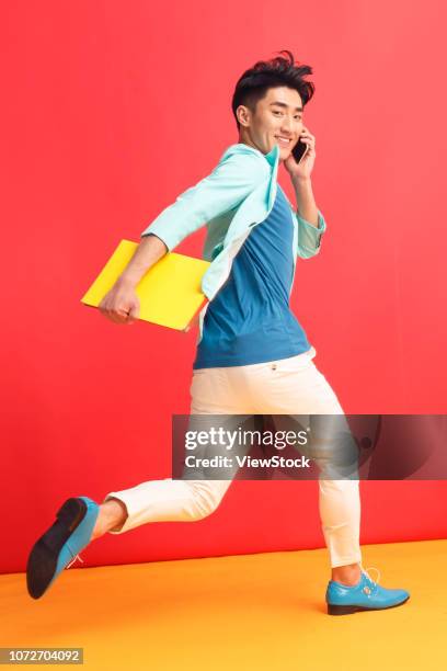 young man running - fashionable asian stock pictures, royalty-free photos & images