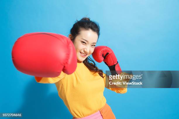 young women boxer - boxing glove coloured background stock pictures, royalty-free photos & images