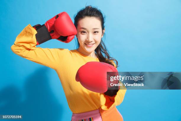 young women boxer - boxing glove coloured background stock pictures, royalty-free photos & images