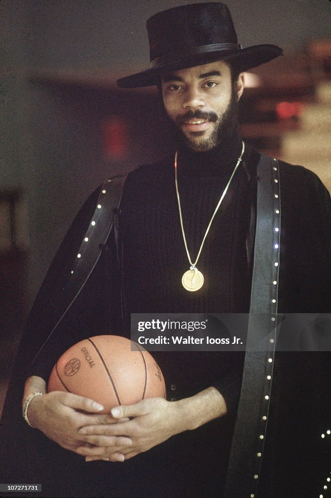 Casual portrait of New York Knicks Walt Frazier with basketball. New