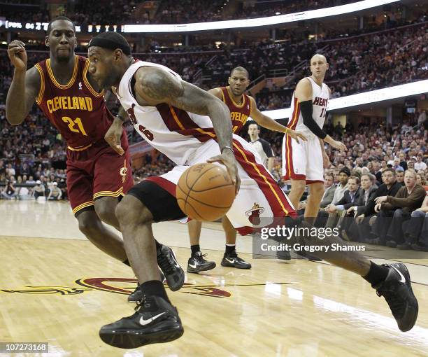 LeBron James of the Miami Heat drives around J.J. Hickson of the Cleveland Cavaliers at Quicken Loans Arena on December 2, 2010 in Cleveland, Ohio....