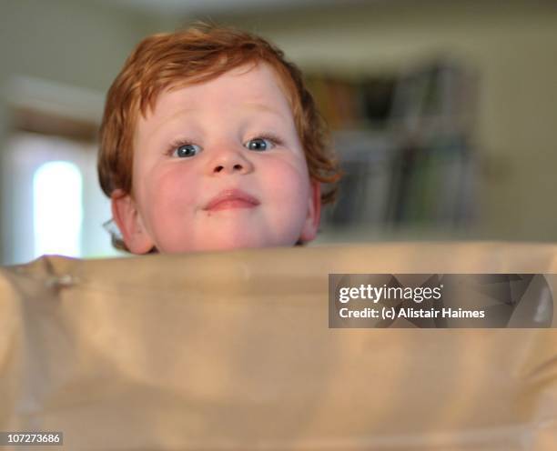 boy with present - flushed cheeks stock pictures, royalty-free photos & images