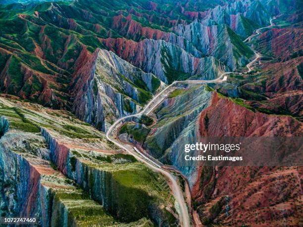 aerial view of road through danxia landform, xinjiang, china - china nature stock-fotos und bilder