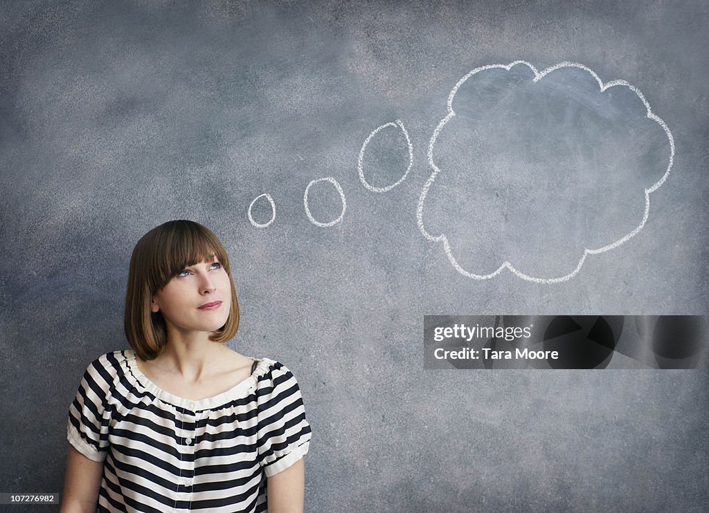 Woman with thought bubble on chalk board