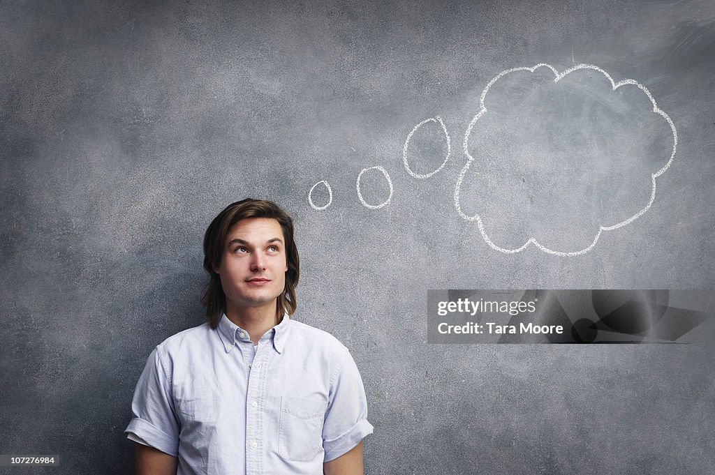 Man with thought bubble on chalk board