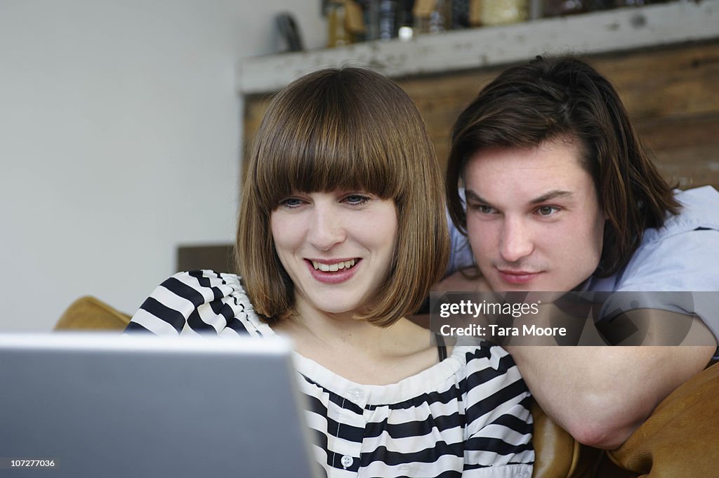 Man and woman looking at laptop