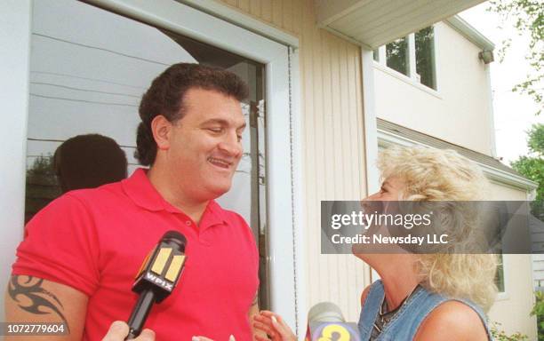 Joey Buttafuoco and his wife Mary Jo share a lighter moment in front of their Massapequa, New York home as they are interviewed by members of the...