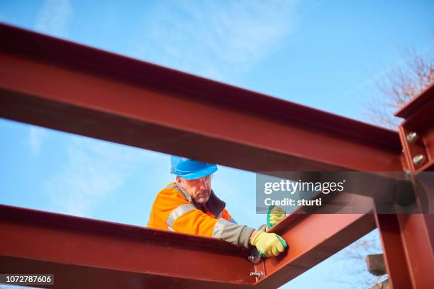 male steel erector - tighten stock pictures, royalty-free photos & images