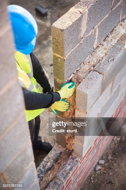 apprentice installing cavity insulation - insulation texture stock pictures, royalty-free photos & images