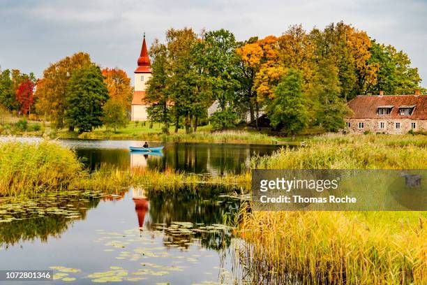 a fisherman on the lake in the landscape of cesis, latvia - cesis latvia stock pictures, royalty-free photos & images