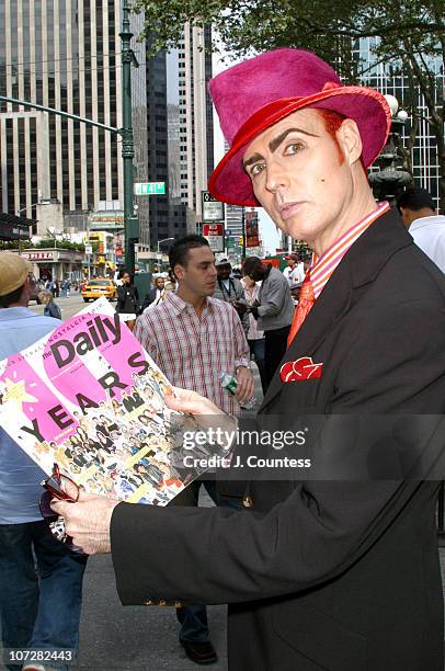 Patrick McDonald receives a copy of "The Daily" during Mercedes Benz Fashion Week publications distribution kick-off.