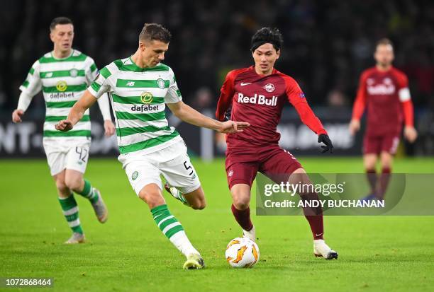 Celtic's Croatian-born Bosnian defender Jozo Simunovic vies with Salzburg's Japanese striker Takumi Minamino during the UEFA Europa League group B...