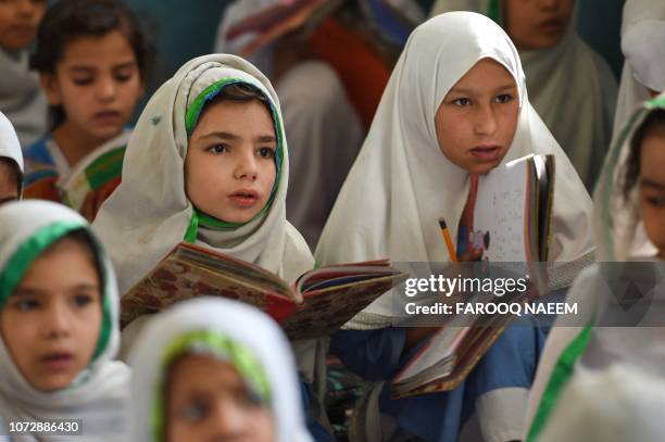 In this picture taken on September 18 girls attend a class at a school in Mingora, a town in Swat Valley. Pakistan sits on a demographic time bomb...