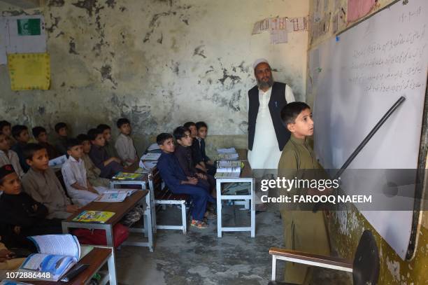 In this picture taken on September 18 boys attend a class at a school in Mingora, a town in Swat Valley. - Pakistan sits on a demographic time bomb...