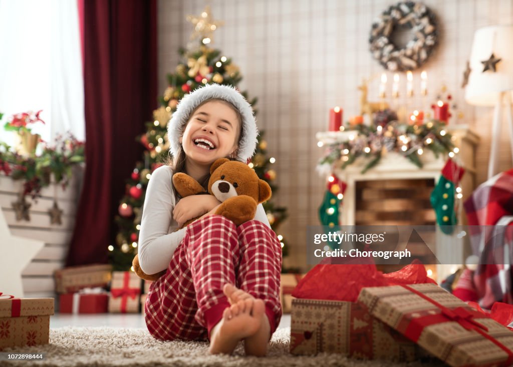 Girl opening Christmas gifts