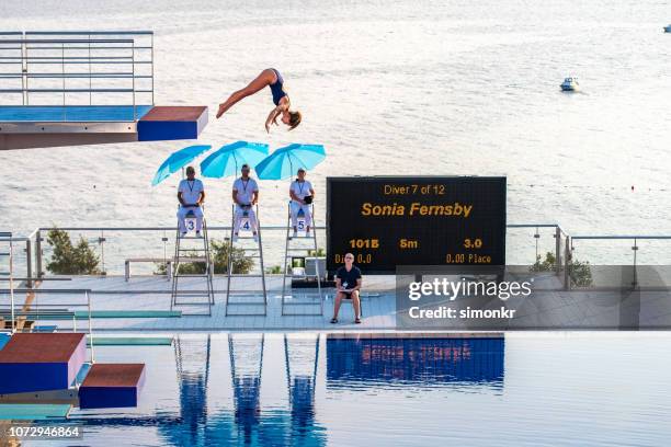 female diver diving in the swimming pool - risk scoring stock pictures, royalty-free photos & images