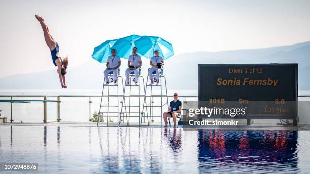 female diver diving in the swimming pool - judge sports official stock pictures, royalty-free photos & images