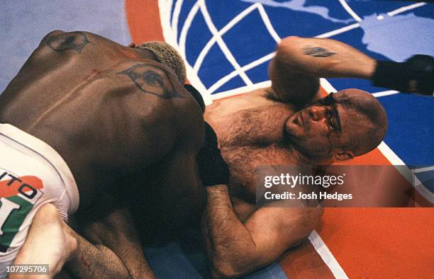 Bas Rutten elbows Kevin Randleman from the bottom during their UFC Heavyweight Championship bout at UFC 20 on May 7, 1999 in Birmingham, Alabama.