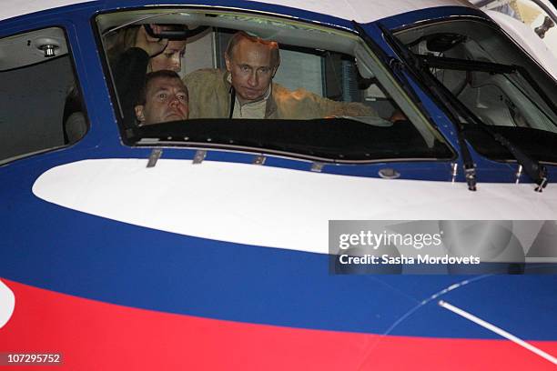 Russian President Dmitry Medvedev and Prime Minister Vladimir Putin examine a new Sukhoi Superjet 100 plane on December 3, 2010 in Sochi, Russia....