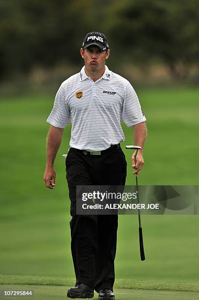 Britain's Lee Westwood reacts after missing a putt on the 7th hole during the 2nd day of the Nedbank Golf Challenge in Sun City on December 3, 2010...