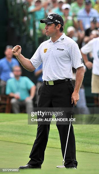 Britain's Lee Westwood celebrates after making a birdie on the 18th hole during the 2nd day of the Nedbank Golf Challenge in Sun City on December 3,...