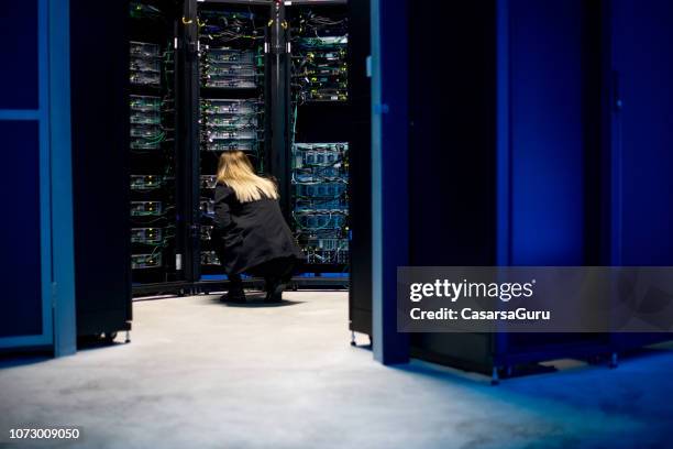 female it technician working in server room - server engineer stock pictures, royalty-free photos & images